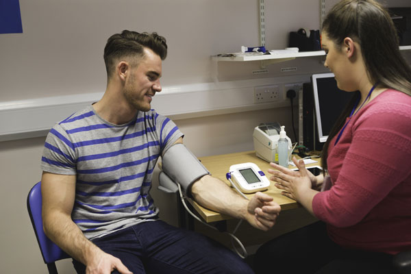 client having his vitals checked by staff