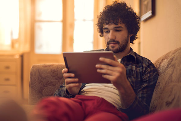 man reading an eboook on a tablet